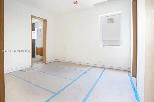 an empty room with windows and yard