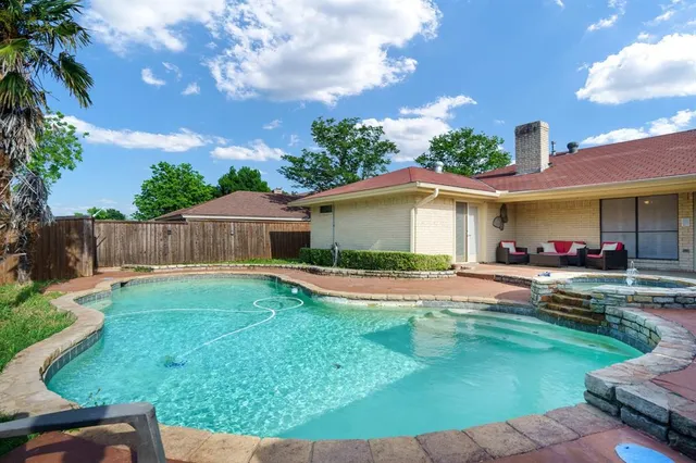 a view of a house with a yard and a patio