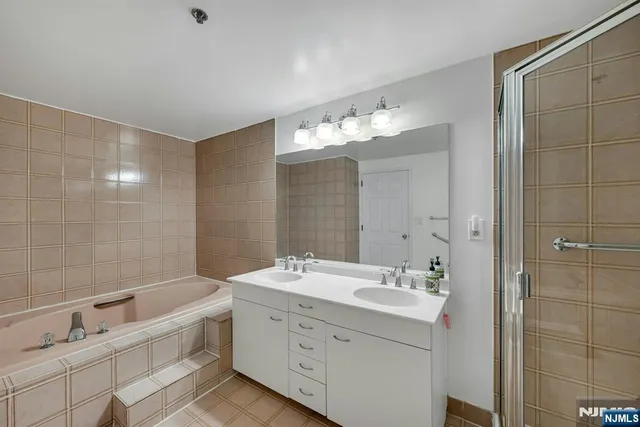 a bathroom with a double vanity sink mirror double and shower