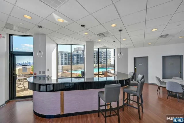 a living room with furniture and large windows