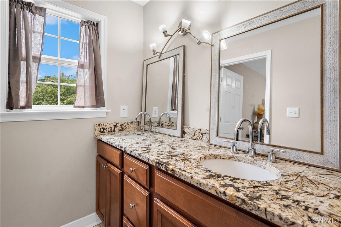 4444 Cogbill Road Richmond, VA 23234 - Photo 25 of 32 Full bathroom featuring double vanity and baseboar