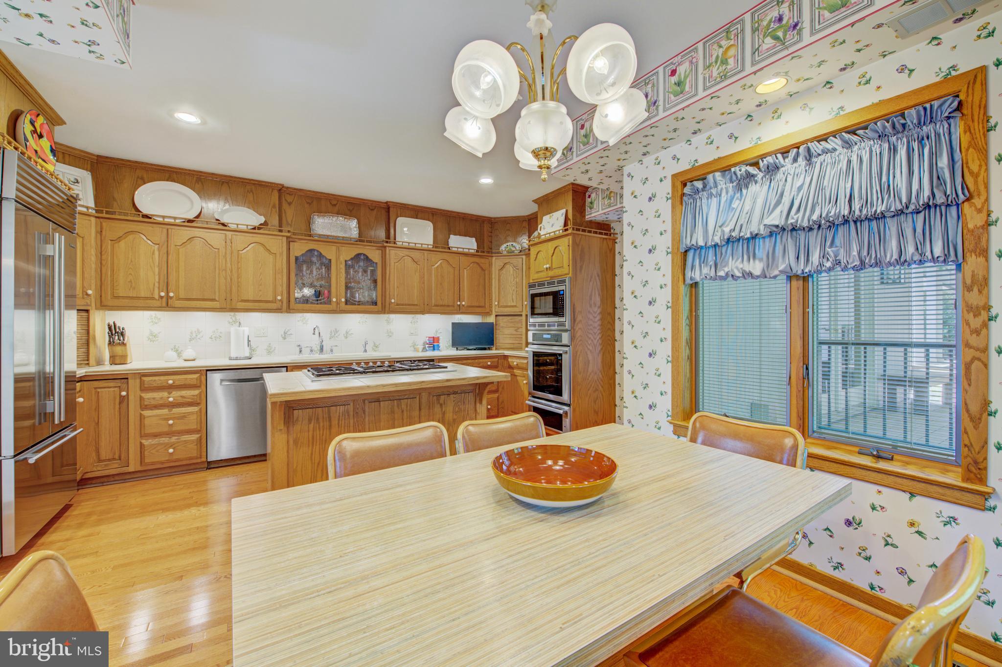 20 Woodbrook Road Voorhees, NJ 08043 - Photo 16 of 46 a kitchen with a table and chairs in it