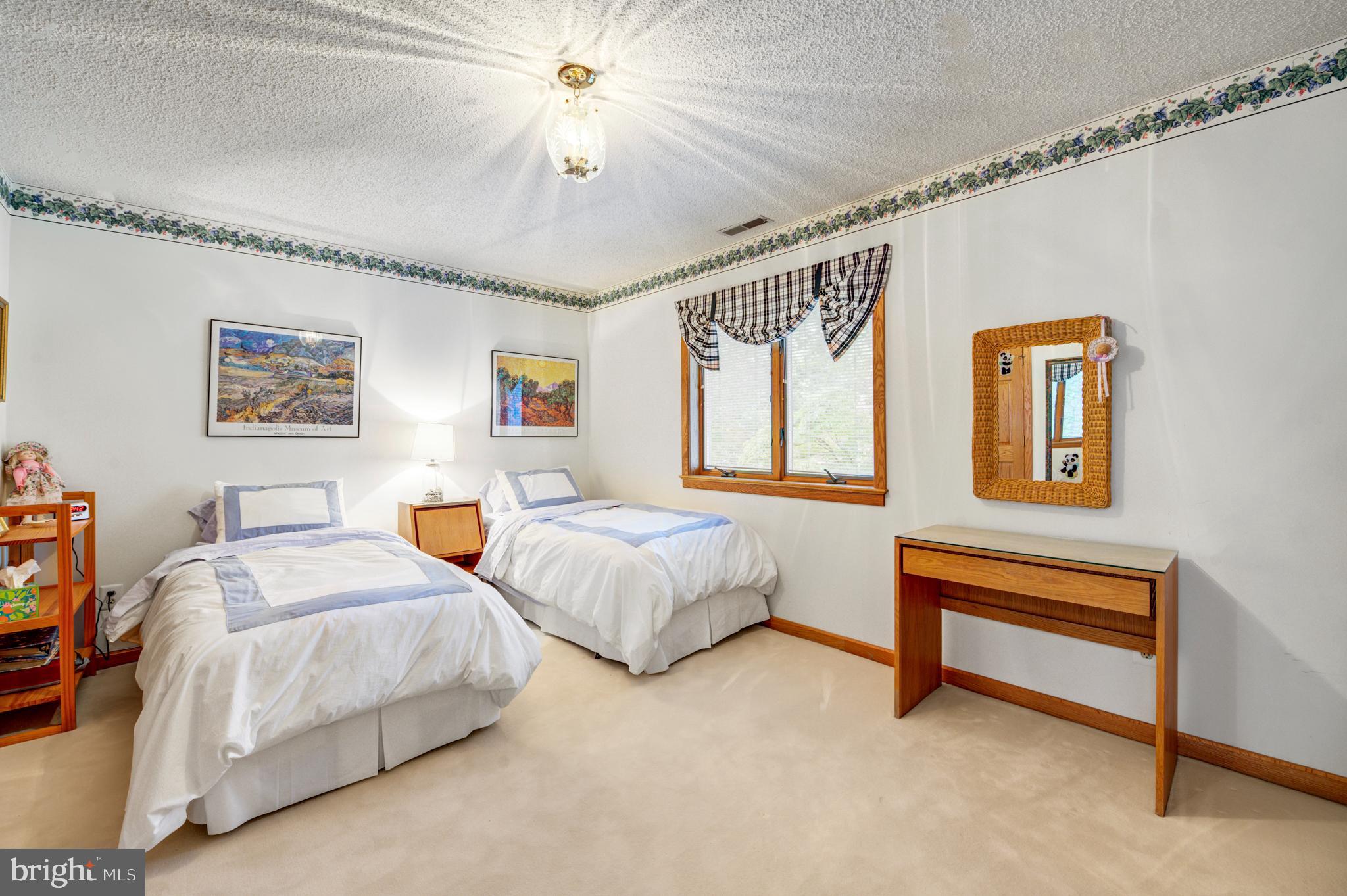 20 Woodbrook Road Voorhees, NJ 08043 - Photo 28 of 46 a spacious bedroom with two beds and a chandelier