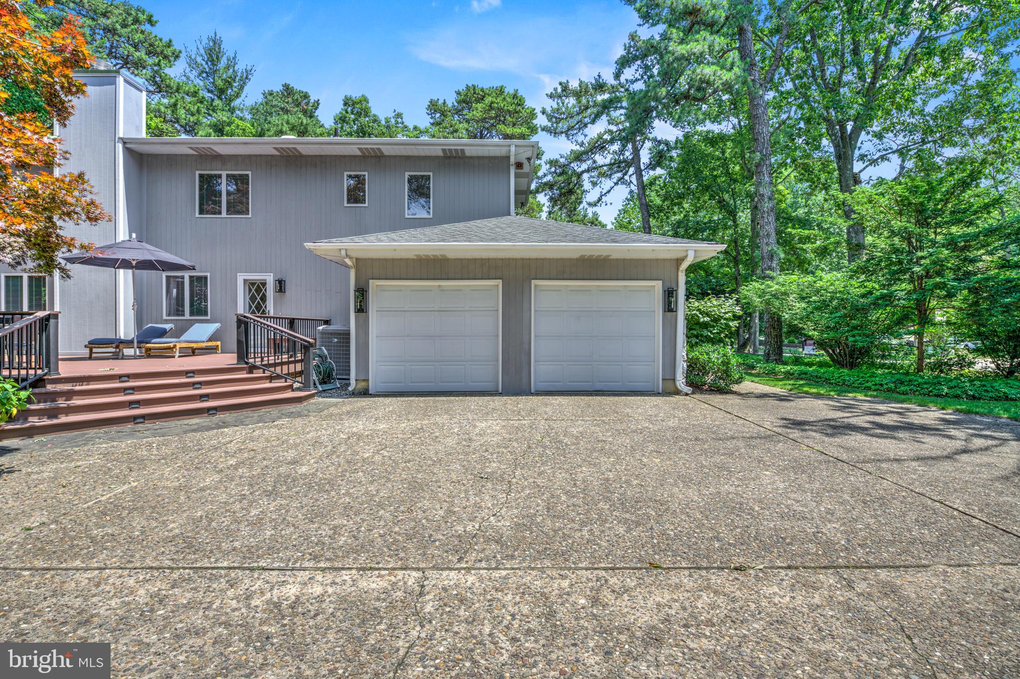 20 Woodbrook Road Voorhees, NJ 08043 - Photo 39 of 46 a front view of a house with a yard and garage