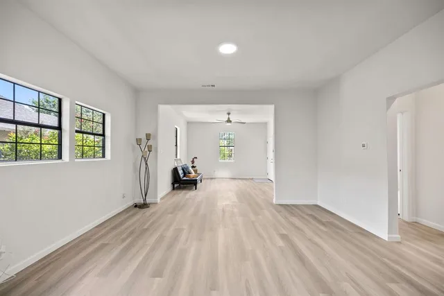 wooden floor in an empty room with a window