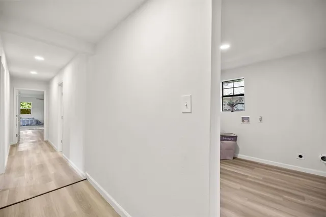 a view of a hallway with wooden floor