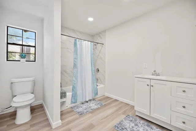 a bathroom with a toilet a sink and a window