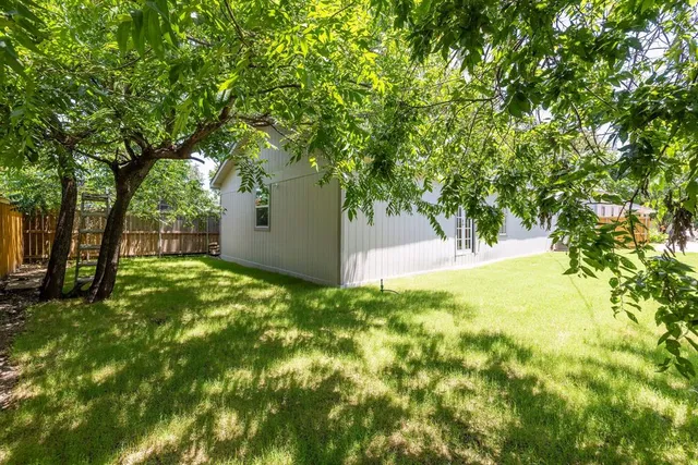 a view of backyard with large trees