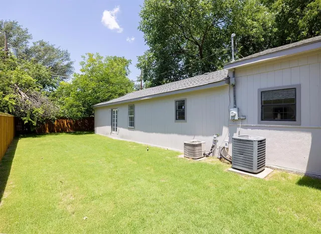 a backyard of a house with table and chairs