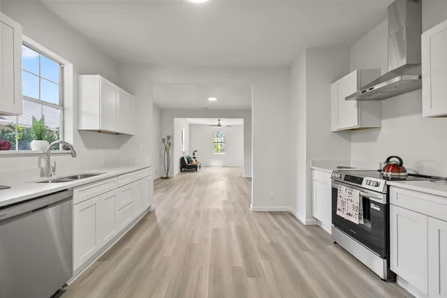 a kitchen with a sink a stove and cabinets
