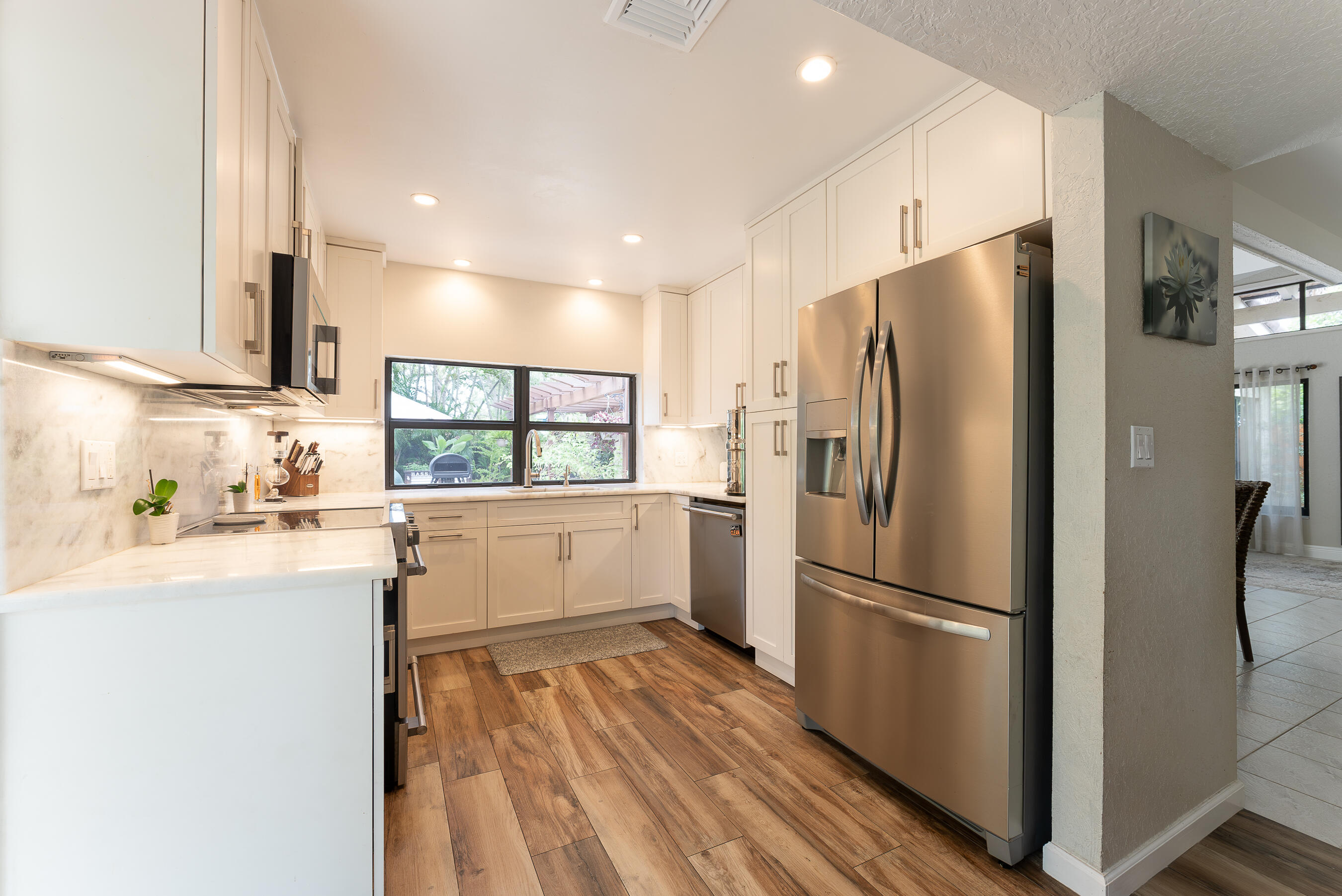 6366 Pond Apple Road Boca Raton, FL 33433 - Photo 7 of 40 a kitchen with a refrigerator a sink and cabinets