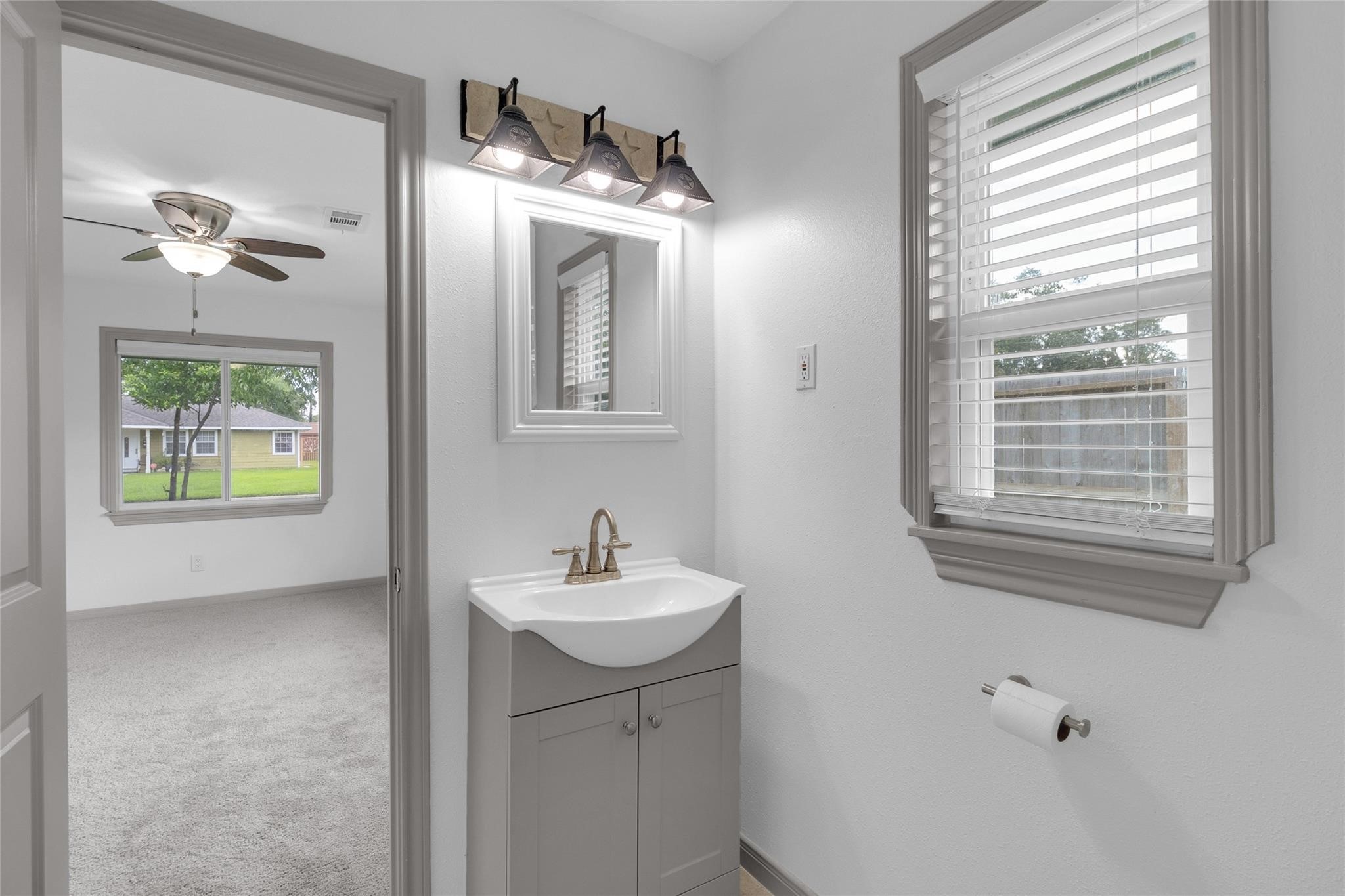 2934 Robertson Street Houston, TX 77009 - Photo 14 of 23 a bathroom with a sink a mirror and a window