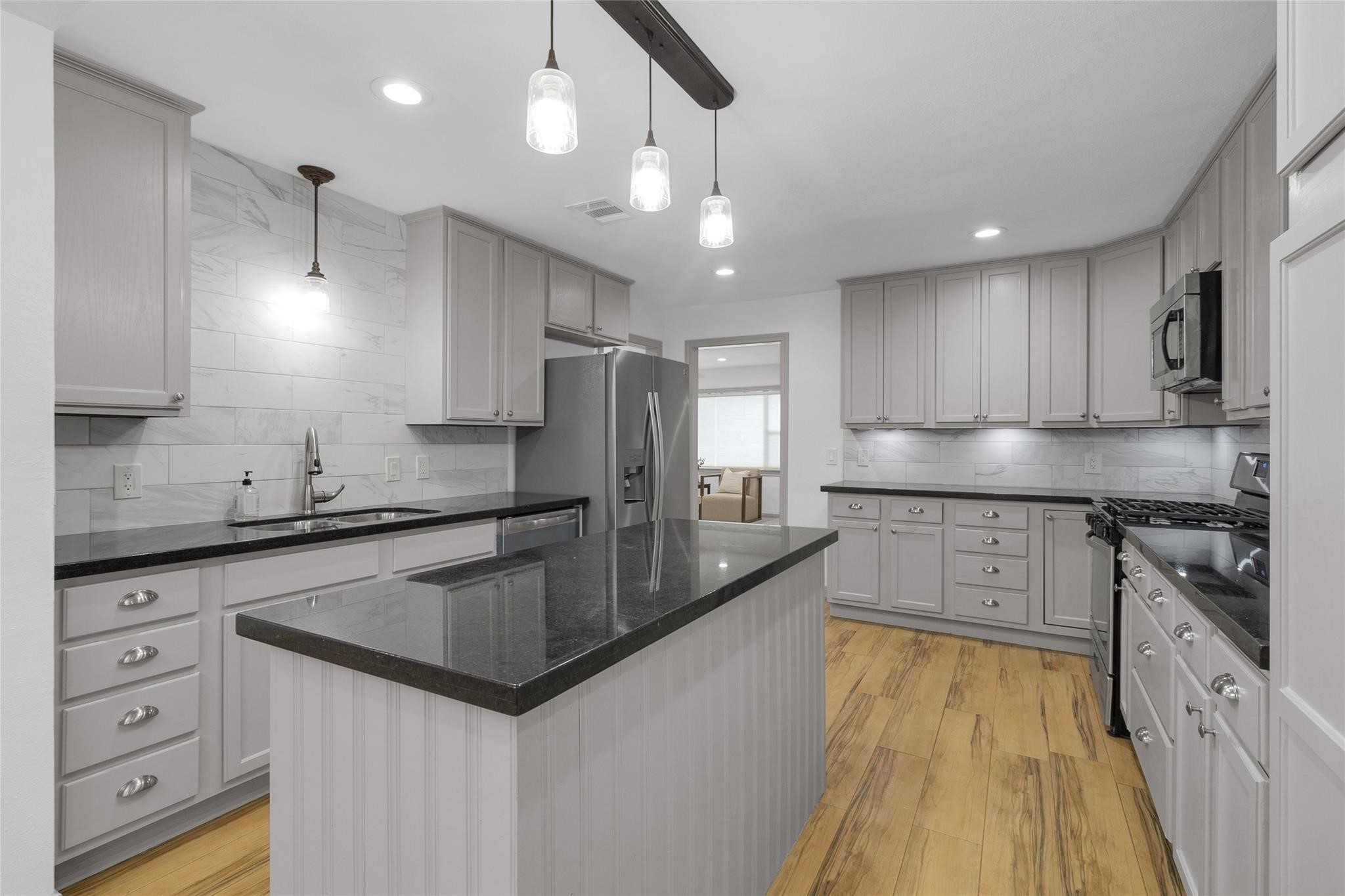 2934 Robertson Street Houston, TX 77009 - Photo 5 of 23 a kitchen with stainless steel appliances granite countertop a sink stove and refrigerator