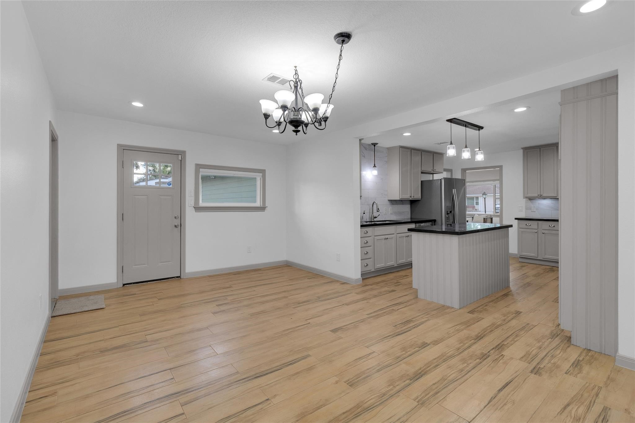 2934 Robertson Street Houston, TX 77009 - Photo 8 of 23 a view of an empty room and kitchen with wooden floor