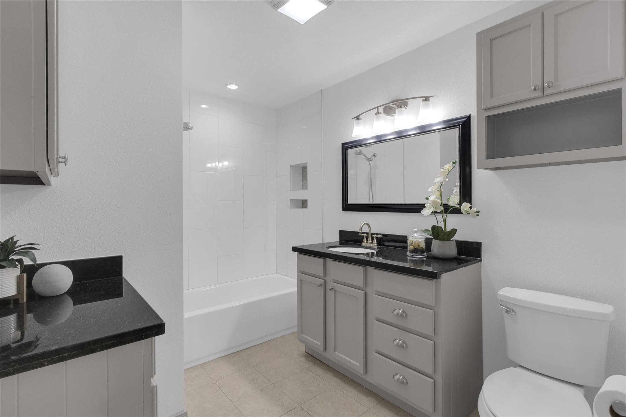 2934 Robertson Street Houston, TX 77009 - Photo 10 of 23 a bathroom with a toilet sink and mirror