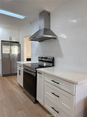 a kitchen with stainless steel appliances a stove and a refrigerator