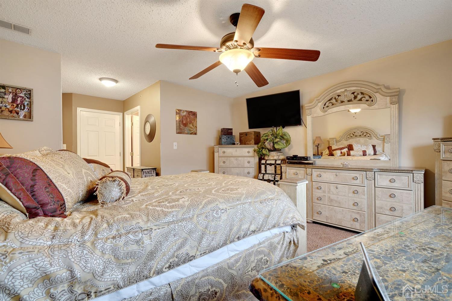 46 Prestwick Way Edison, NJ 08820 - Photo 15 of 24 a bedroom with a large bed and a flat tv screen