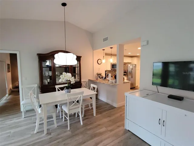 a view of a dining room with furniture wooden floor and chandelier