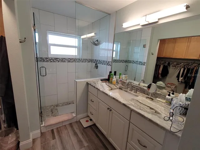 a bathroom with a double vanity sink mirror and shower