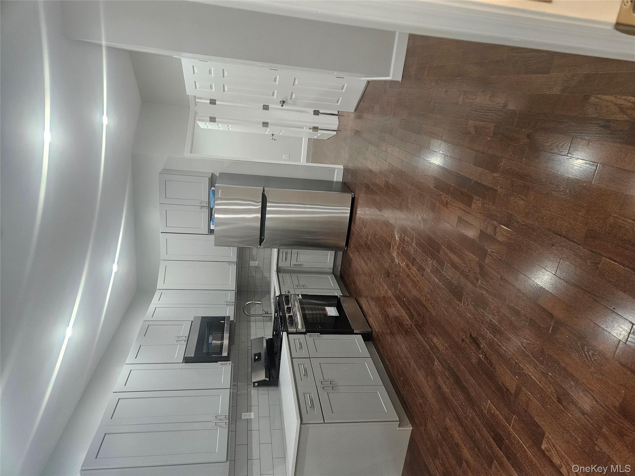 94-19 116th Street Queens, NY 11419 - Photo 7 of 7 a kitchen with granite countertop a refrigerator and a stove top oven