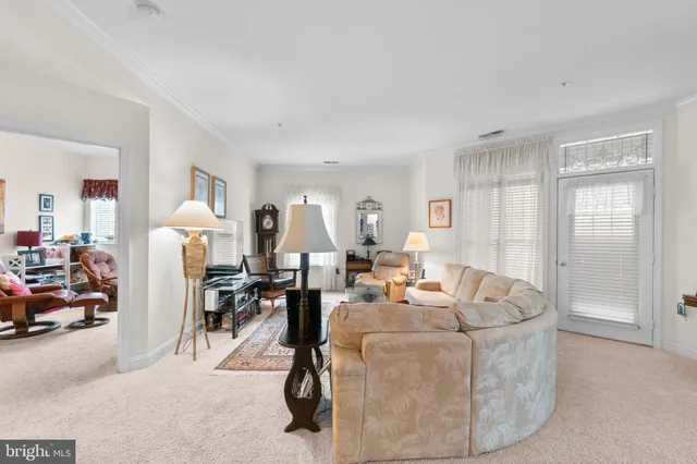 a living room with furniture a dining table and chairs