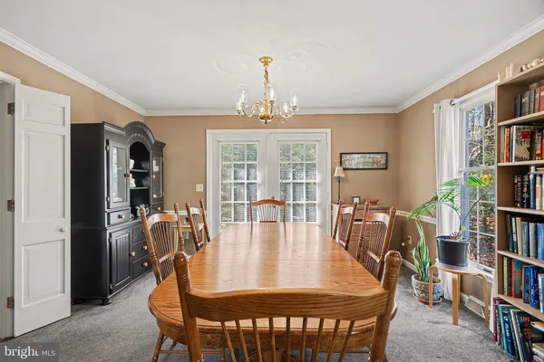a view of a dining room with furniture and a book shelf