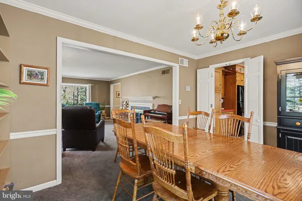 a view of a dining room with furniture and chandelier