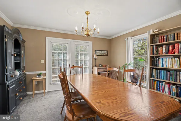 a dining room with furniture a book and a chandelier