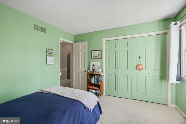 a bedroom with a bed and a mirror