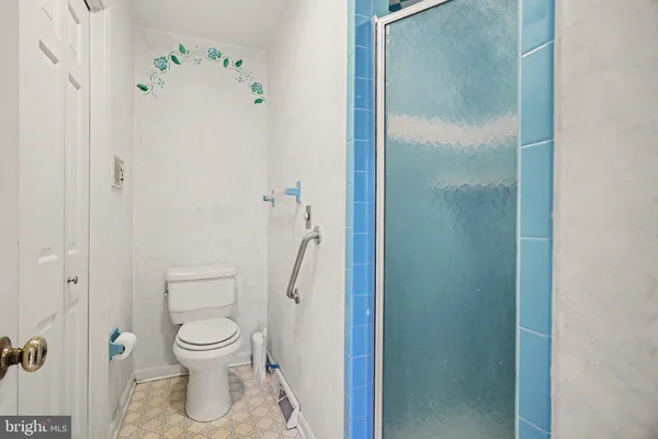 a white toilet sitting next to a bathroom sink