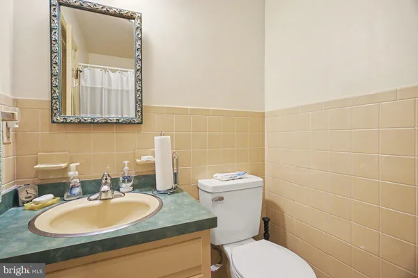 a bathroom with a sink a toilet and mirror