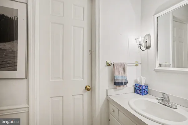 a bathroom with a sink vanity and a mirror