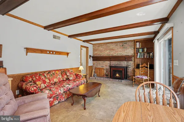 a living room with furniture a fireplace and city view