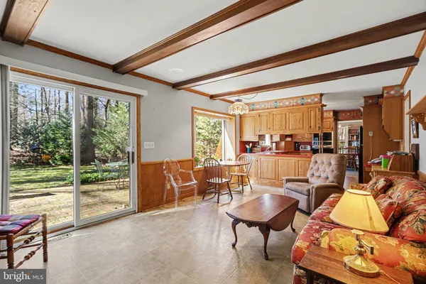 a living room with furniture and a floor to ceiling window