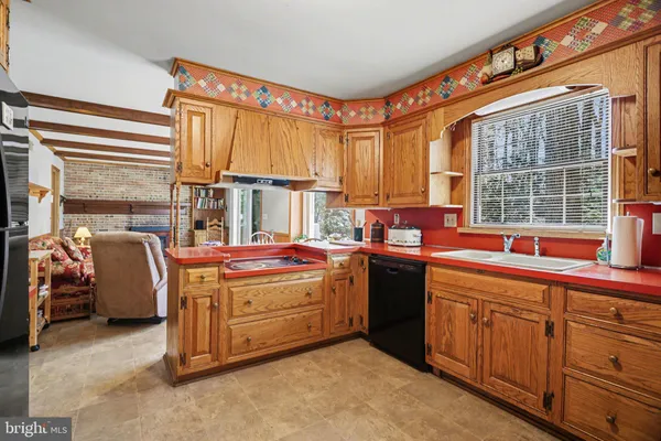 a open kitchen that has a sink and a large window