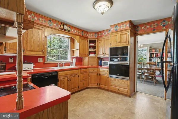 a kitchen with a stove a sink and a refrigerator