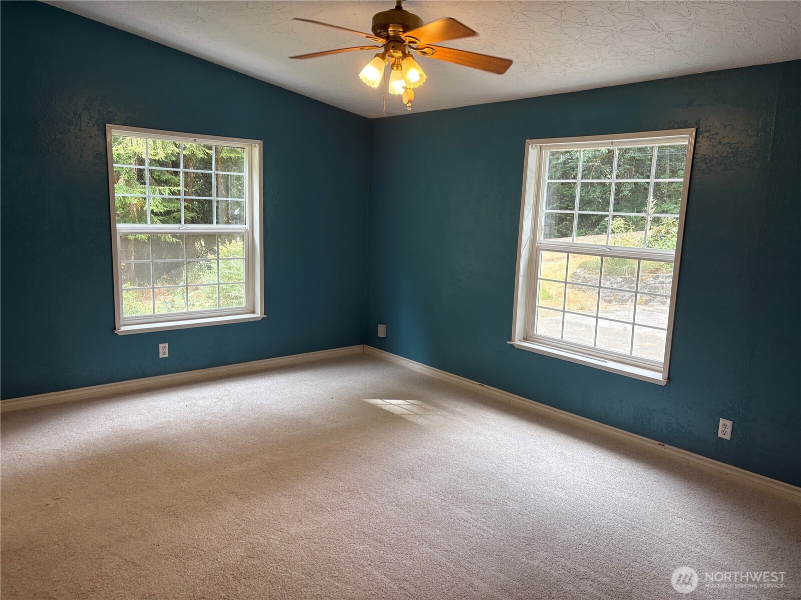 17411 64th St Court Northwest Vaughn, WA 98394 - Photo 17 of 27 a view of a livingroom with a ceiling fan and window