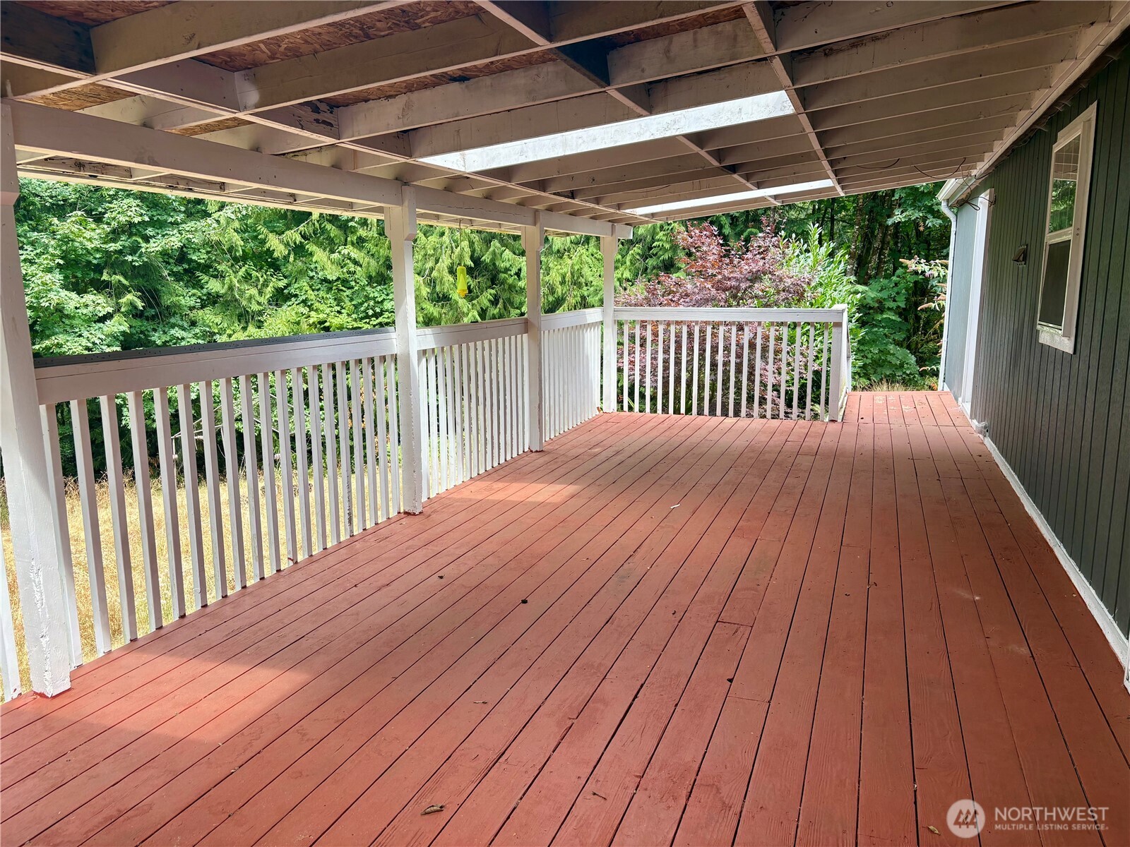 17411 64th St Court Northwest Vaughn, WA 98394 - Photo 6 of 27 a balcony with wooden floor