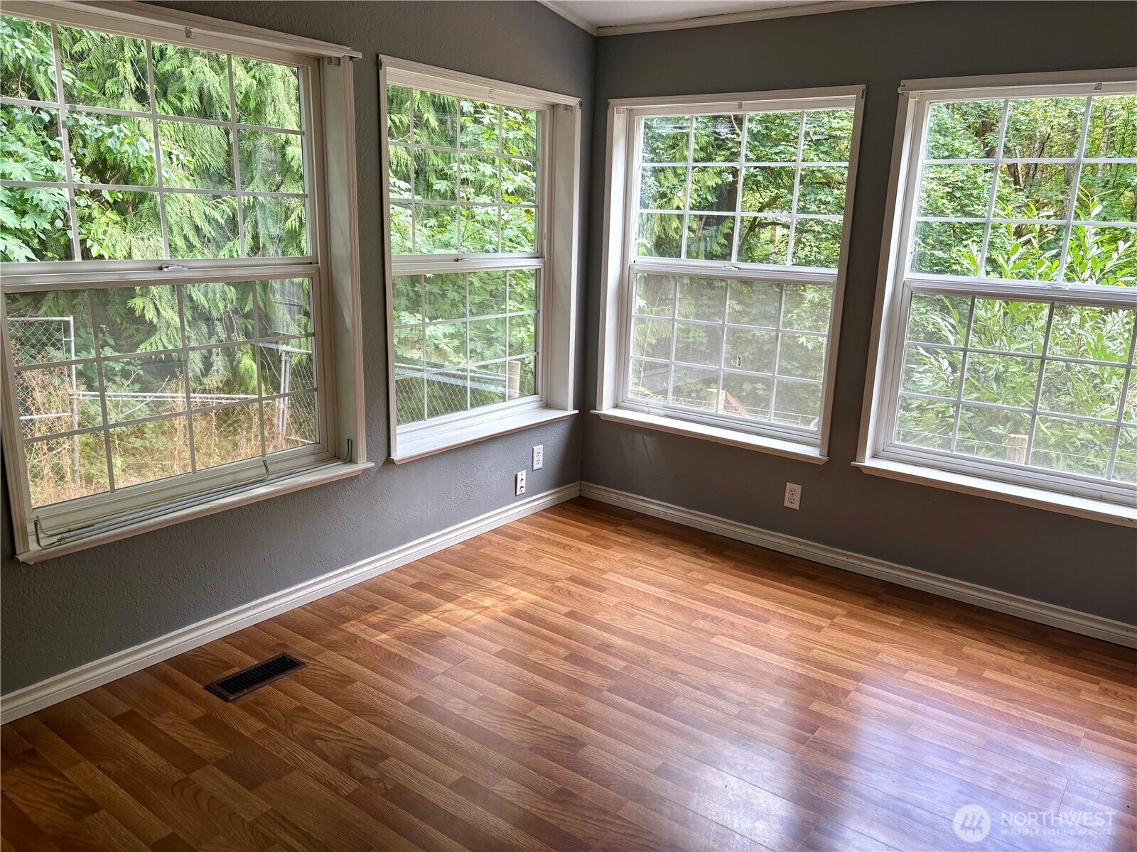 17411 64th St Court Northwest Vaughn, WA 98394 - Photo 8 of 27 a view of an empty room with wooden floor and a window