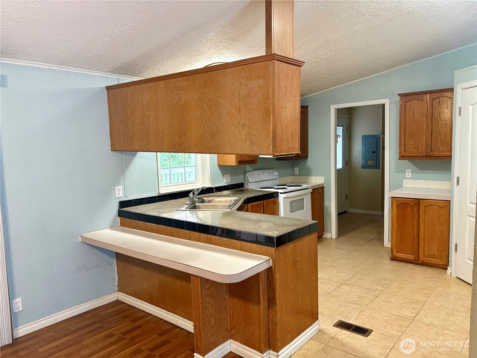 17411 64th St Court Northwest Vaughn, WA 98394 - Photo 10 of 27 a kitchen with stainless steel appliances granite countertop a sink a stove and cabinets