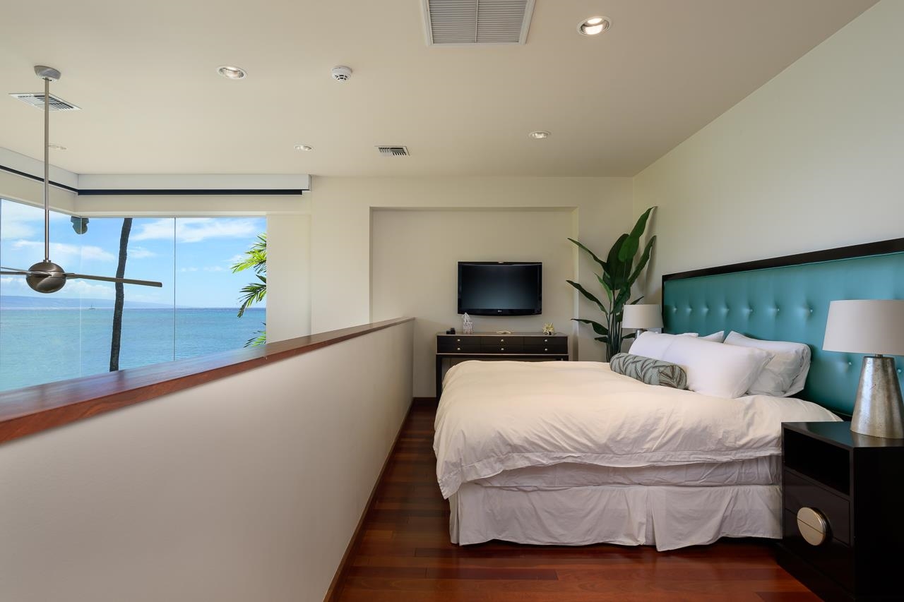 4809 Lower Honoapiilani Road Lahaina, HI 96761 - Photo 43 of 49 a bedroom with a large bed and a flat tv screen on the dresser