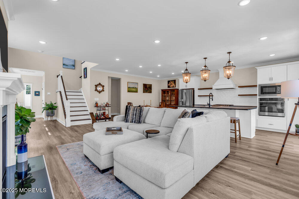 3028 Quail Rdg Boulevard, Unit 606 Farmingdale, NJ 07727 - Photo 12 of 82 a living room with furniture white wooden floor and kitchen view