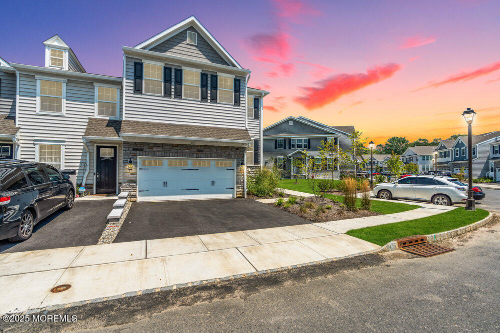 3028 Quail Rdg Boulevard, Unit 606 Farmingdale, NJ 07727 - Photo 2 of 82 a front view of a house with garden