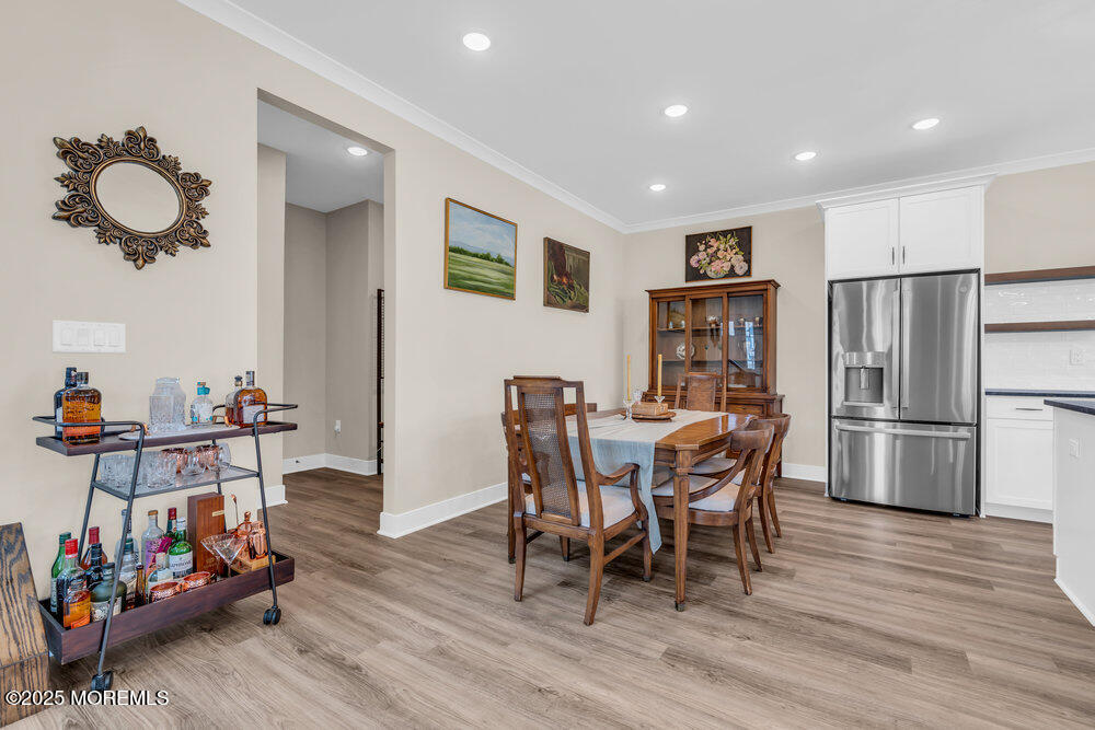 3028 Quail Rdg Boulevard, Unit 606 Farmingdale, NJ 07727 - Photo 22 of 82 a view of a dining room with furniture and wooden floor