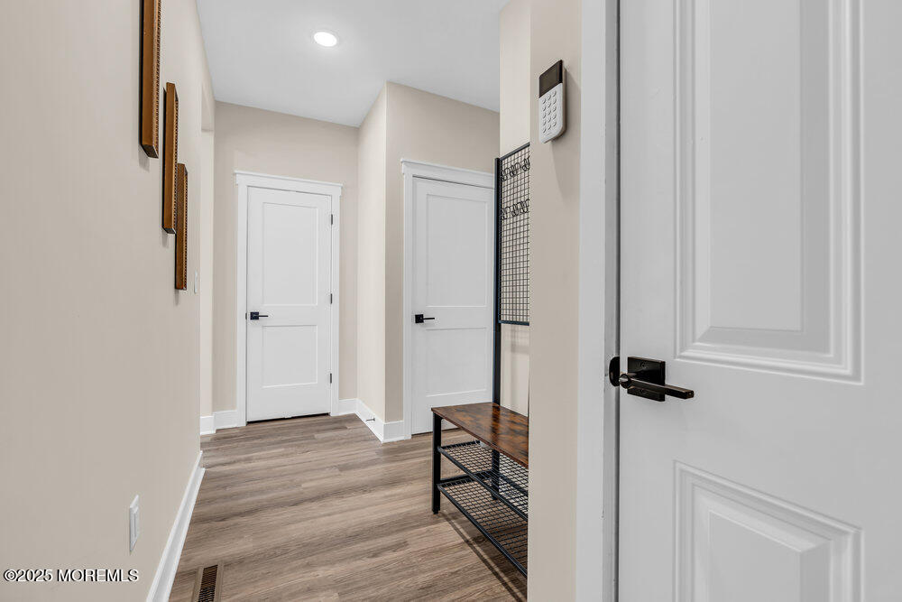 3028 Quail Rdg Boulevard, Unit 606 Farmingdale, NJ 07727 - Photo 26 of 82 a view of a hallway with wooden floor and closet