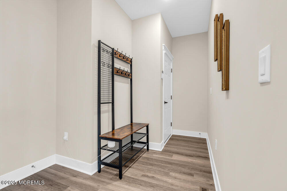 3028 Quail Rdg Boulevard, Unit 606 Farmingdale, NJ 07727 - Photo 27 of 82 a view of a room with wooden floor and chair