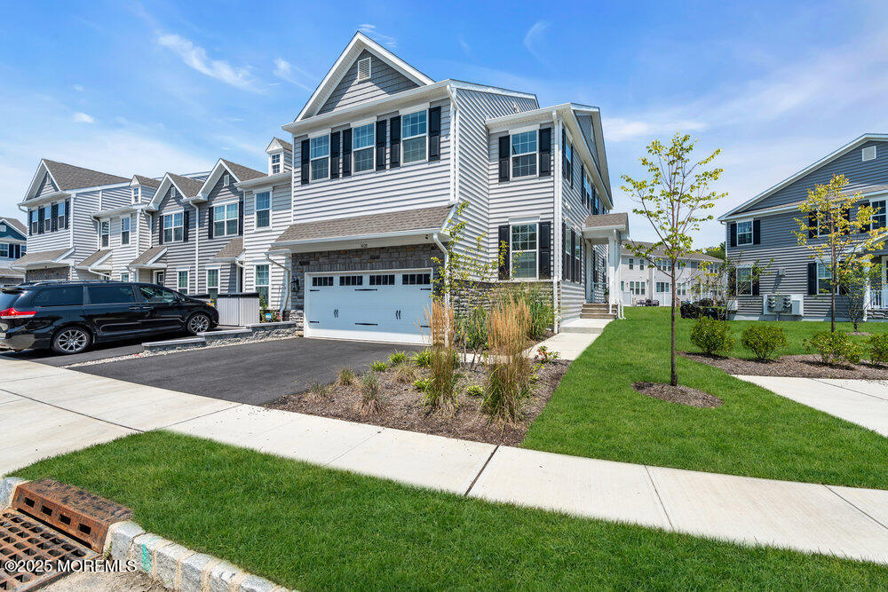 3028 Quail Rdg Boulevard, Unit 606 Farmingdale, NJ 07727 - Photo 3 of 82 a front view of a house with a yard