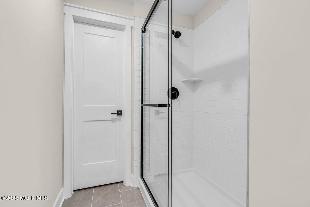 3028 Quail Rdg Boulevard, Unit 606 Farmingdale, NJ 07727 - Photo 31 of 82 a bathroom with a glass shower door