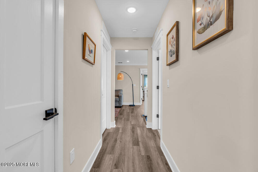 3028 Quail Rdg Boulevard, Unit 606 Farmingdale, NJ 07727 - Photo 35 of 82 a view of a hallway with wooden floor and closet