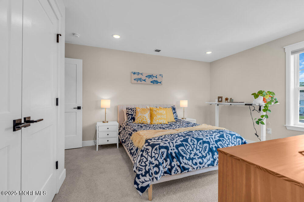 3028 Quail Rdg Boulevard, Unit 606 Farmingdale, NJ 07727 - Photo 39 of 82 a bedroom with a bed and a table